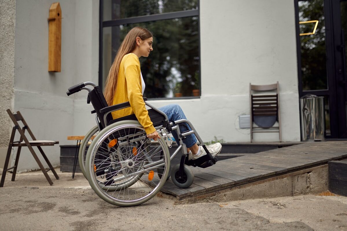 Woman using a wheelchair ramp