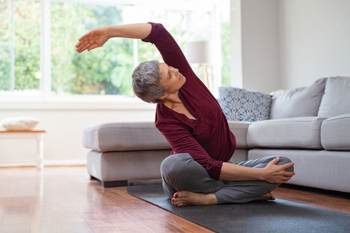 Older woman doing yoga at home