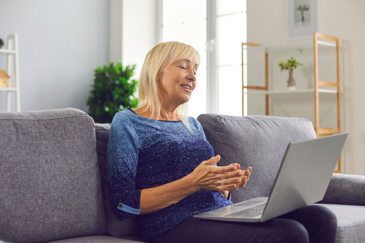 Older lady on a video call to family on a laptop